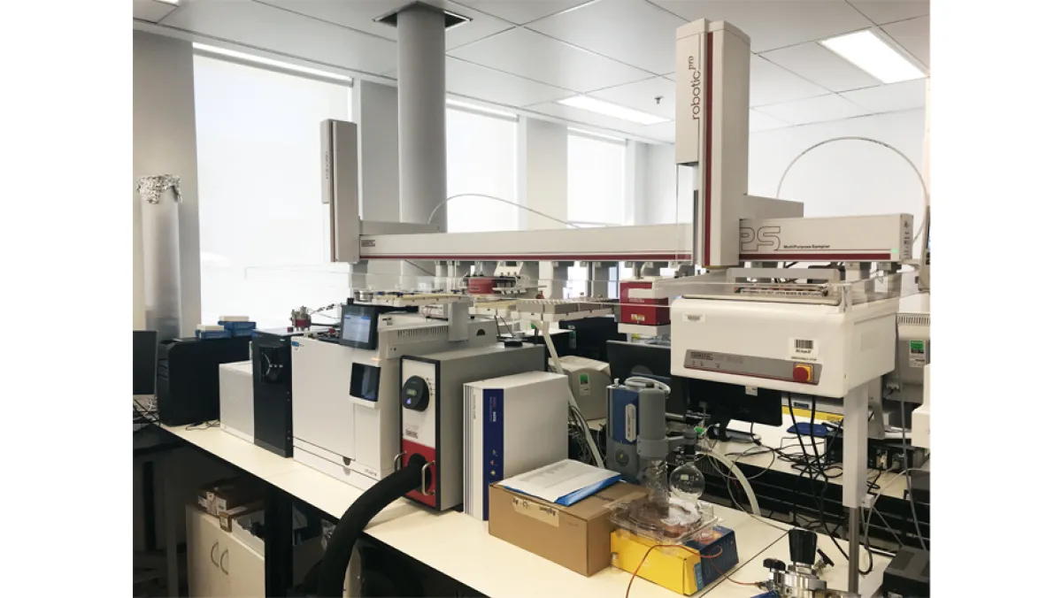 A modern laboratory filled with various scientific instruments and computers under bright lighting.